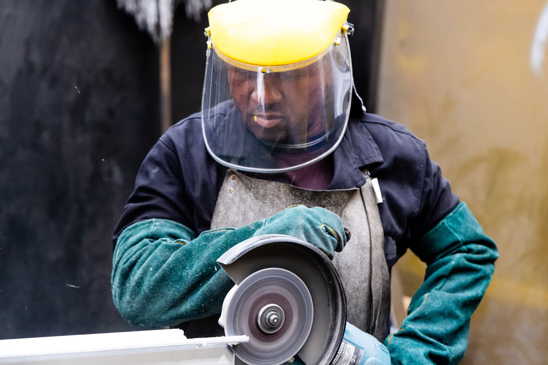 MRD fabricator grinding a roller shutter door component